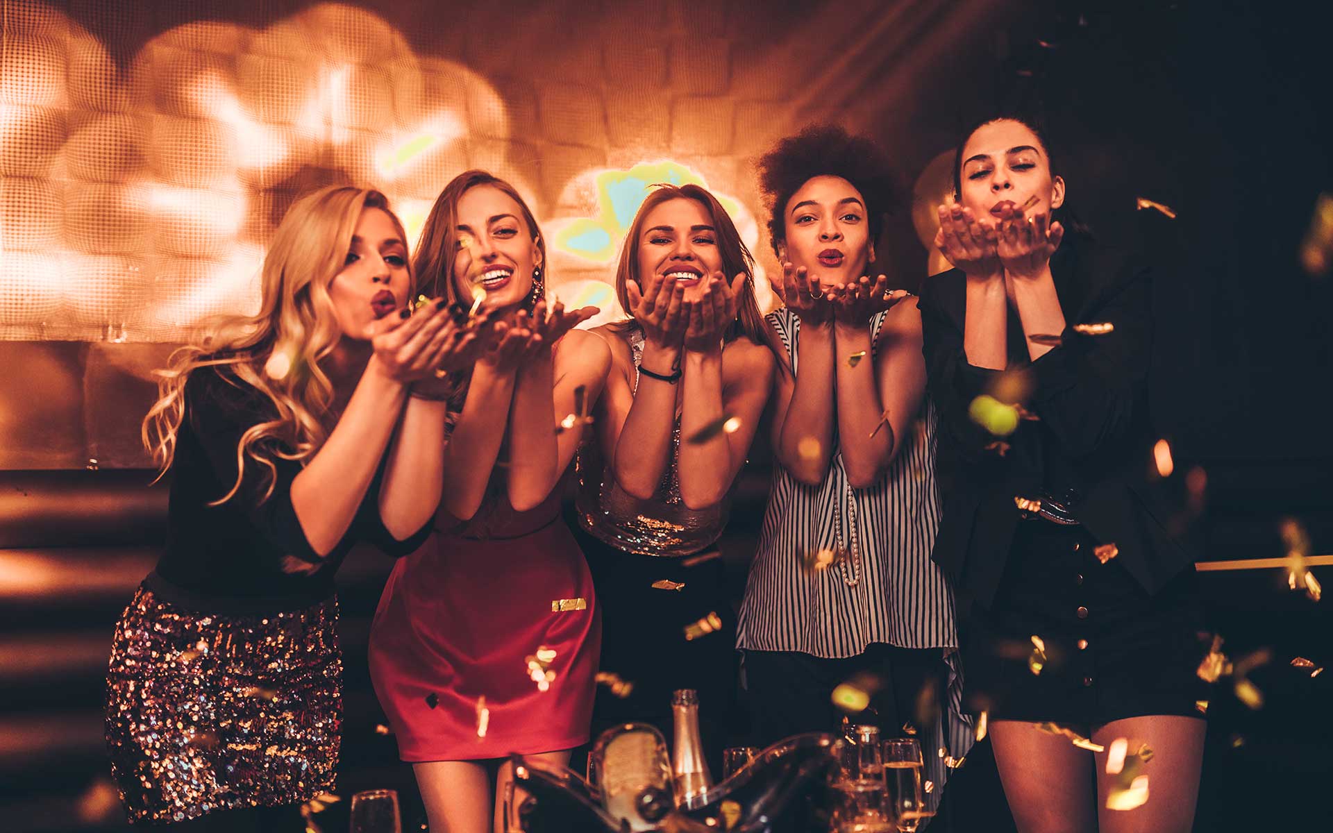 Group of girls blowing kisses in club